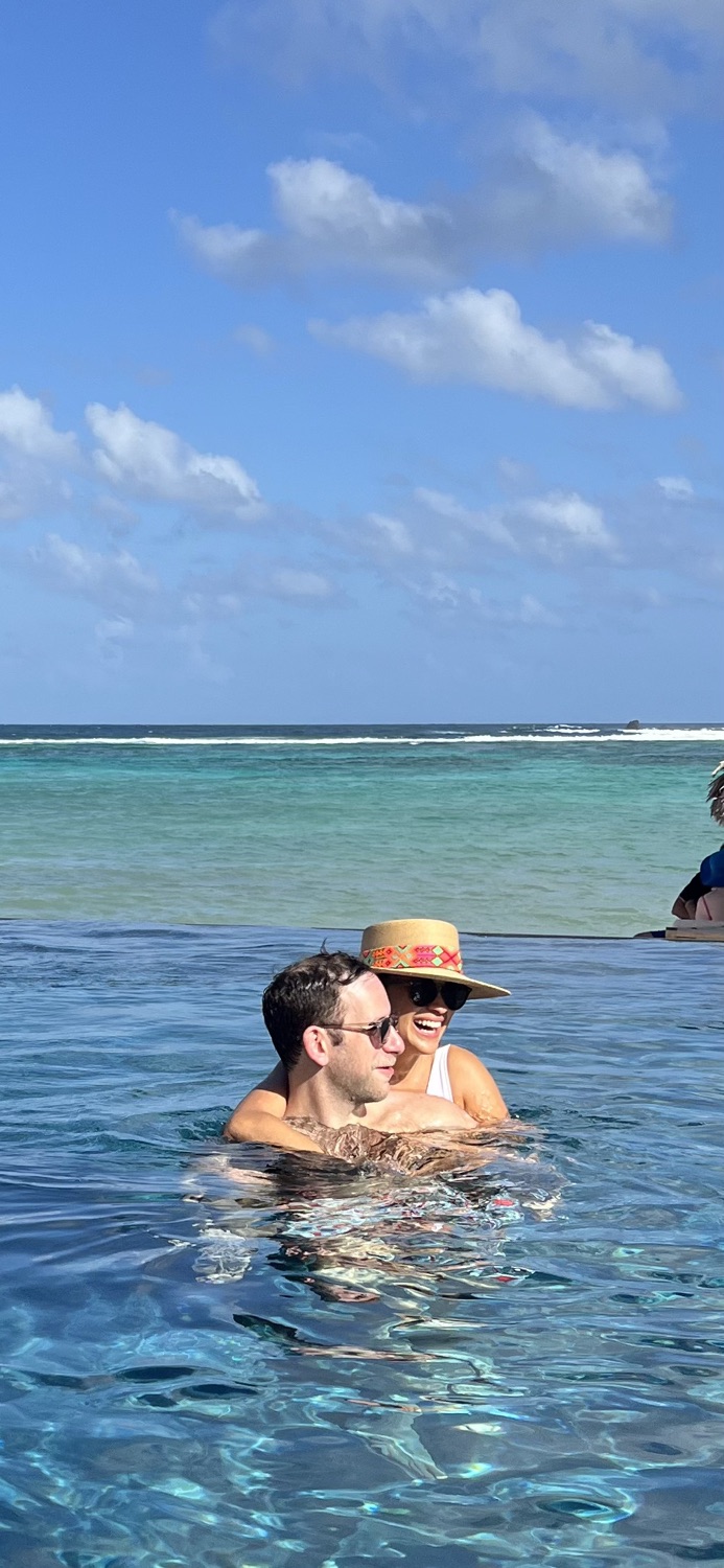 Salma and Eric in a pool overlooking the sea in St. Barths